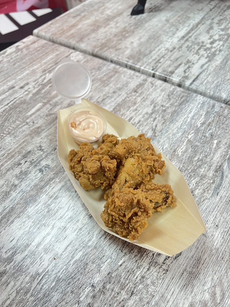Fried chicken pieces with a dip